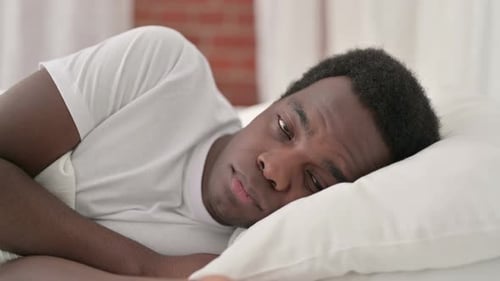 Un Africain inquiet réveillé dans son lit