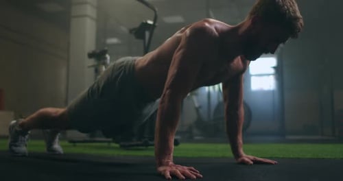 Man Doing Push Ups in a Gym. Exhaling and Inhaling After Push-ups and Exercise. Perfect for Fitness