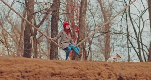 Girl on a Rope Swing with her Dog