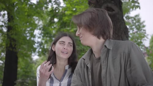 Portrait Young Happy Couple in Casual Clothes Spending Time Together in the Park, Having a Date