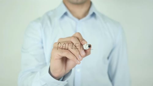 Man Writing Patience with a Marker