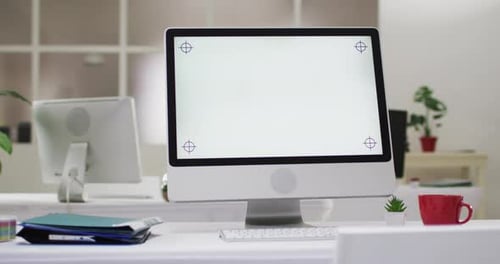 View of computer screen and office supplies on desk at office