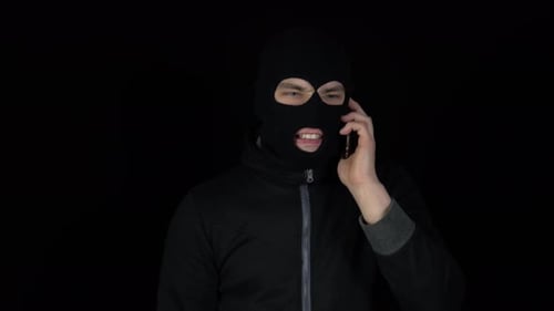 Masked Figure Anrily Talking on Phone