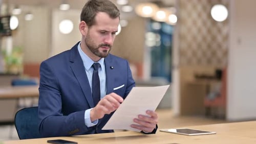 Businessman Working Reading Documents in Office