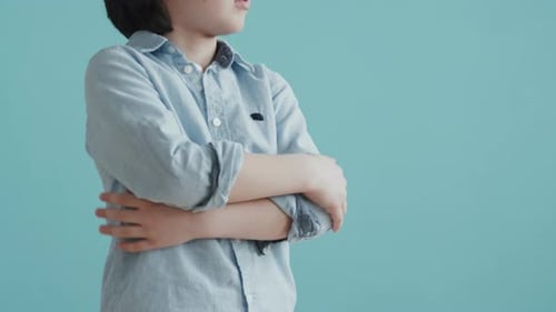 Handsome Child Posing Against Aqua Background
