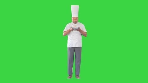 Happy Chef Looking at Camera Holding a Dessert on a Green Screen Chroma Key
