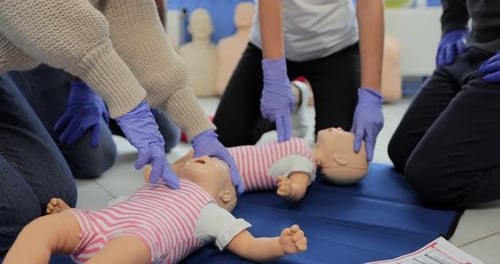 Close Up of Group of Multiethnic People During the First Aid Training with Instructor Showing on