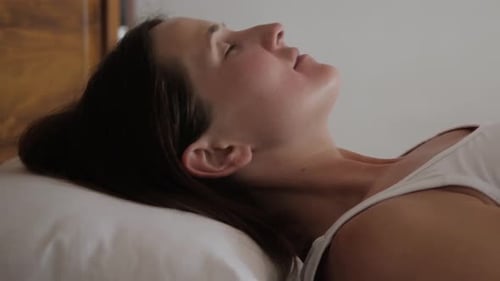 Woman Resting Calmly in Bed Close Up
