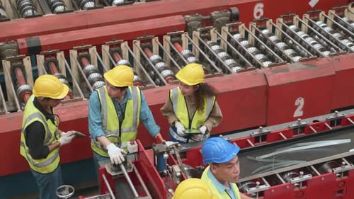 Team worker walk teaching help friend operate control heavy machine in factory with many equipment