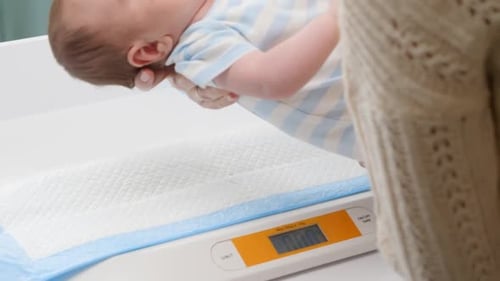 Infant Weighed on Scale in Hospital Room