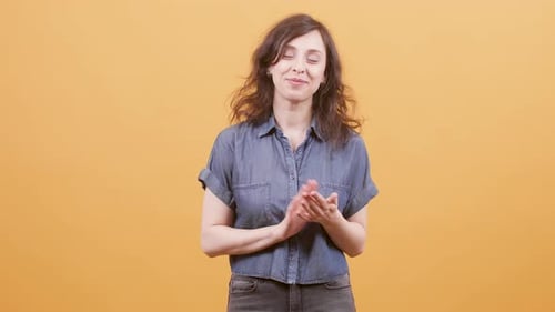 Woman Smiling and Clapping in Studio