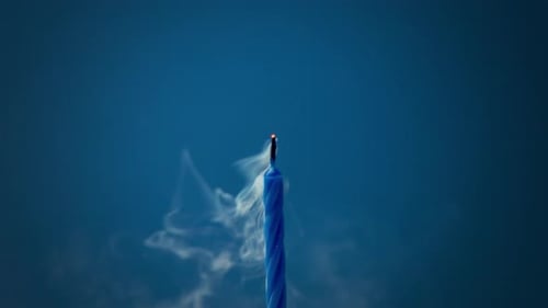 Single Blue Birthday Candle Burning and Extinguished