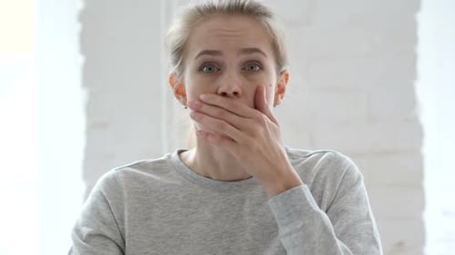 Shocked Woman Reacting with Surprise Indoors