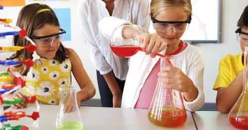 School kids doing a chemical experiment in laboratory