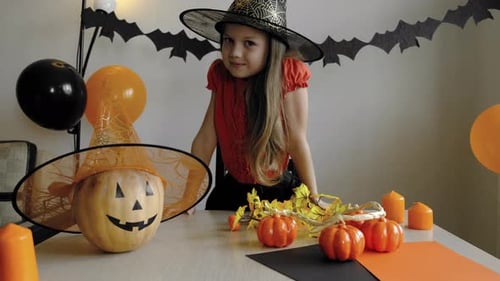 Girl in Witch Costume Preparing for Halloween Party
