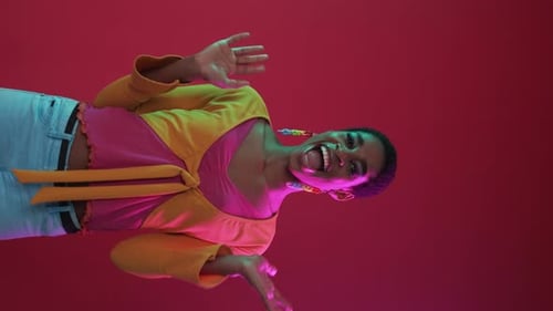 Stylish Woman Dancing in a Vibrant Studio