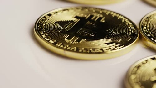 Gold Bitcoin Coins on White Surface