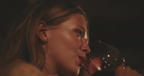 Woman takes a sip of Red Wine