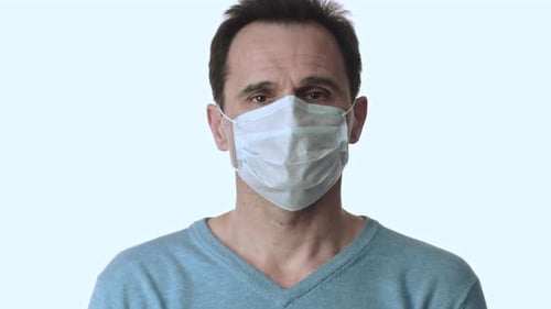 Man Removes Surgical Mask, Close Up