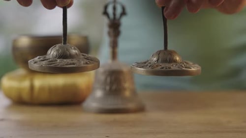 Sound Healing Bells Held Between Fingers