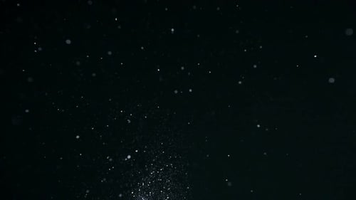 White glitter on black background, Slow Motion