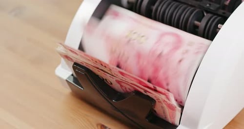 Money Counter Counts Currency Rapidly in Close-Up
