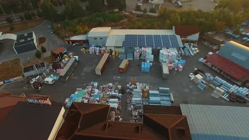 Logistic transportation terminal. Aerial drone view of large modern industrial warehouse