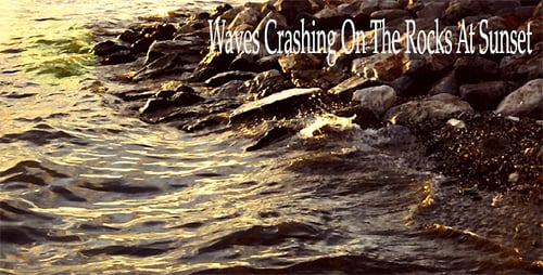 Waves Gently Lapping Rocky Shoreline at Sunset