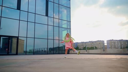 Happy Child Dancing on a City Rooftop