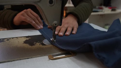 Tailor Sews Trousers On The Sewing Machine 1
