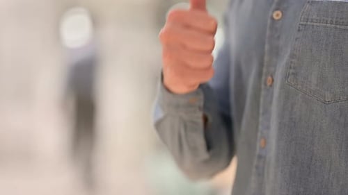 Hand Giving Approval with Thumbs Up