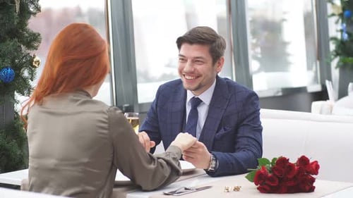 Young Caucasian Couple Celebrating Saint Valentines Day in Restaurant.
