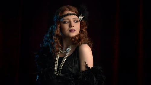 Portrait of Old-fashioned Red Haired Woman Dressed in Roaring Twenties Era Flirting and Posing on