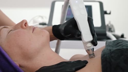 Woman Receiving Beauty Treatment on Neck in Clinic