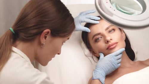 Dermatologist Checking Female Skin at Beauty Clinic