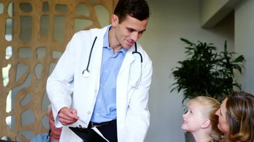 Friendly Doctor Discusses Health With Child And Mother