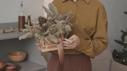 Woman Sets Festive Christmas Dinner Table