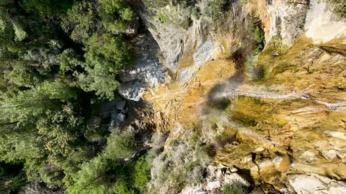 A small waterfall in the mountains aerial view 4 K