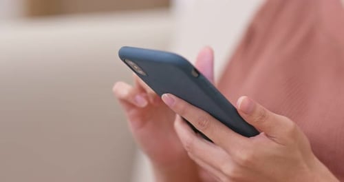 Close Up of Person Using Smart Phone Indoors