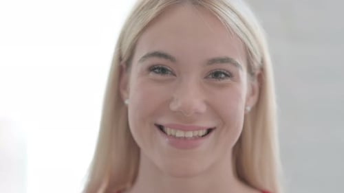 Close Up of Young Blonde Woman Smiling at Camera