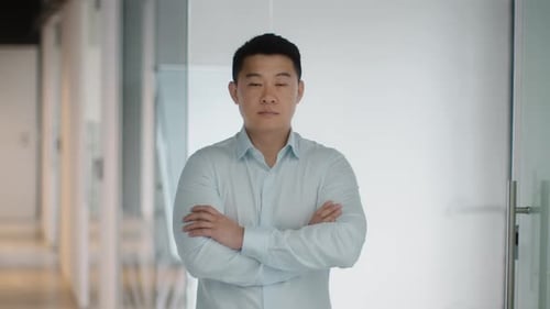 Confident Man Standing in a Modern Office