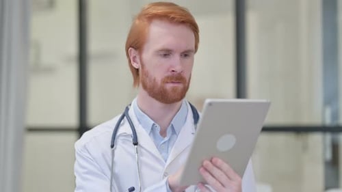 Doctor Uses Tablet Computer in Hospital Office