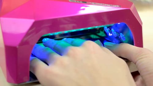 Female Fingers in Pink Drying Machine.