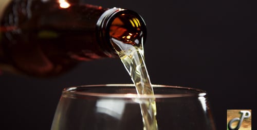 Pouring Liquid into Glass Close-Up on Dark Background