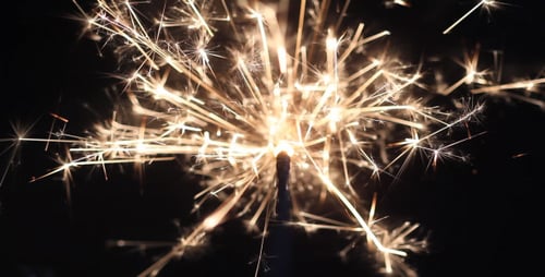Sparkling Golden Sparkler Emitting Bright Light at Night