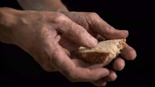 Dirty Hands Breaking Bread for Basic Sustenance