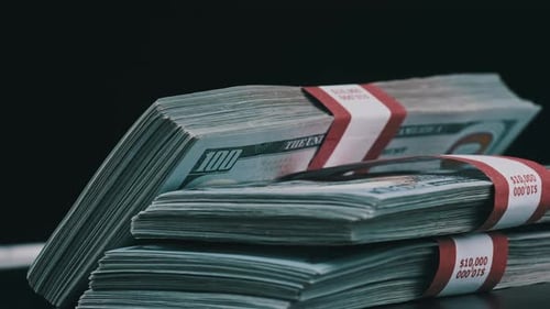 Bundles of Dollars Rotate on Black Background