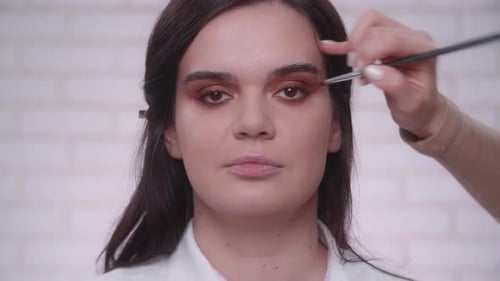 Woman Getting Eye Makeup Applied in a Close Up