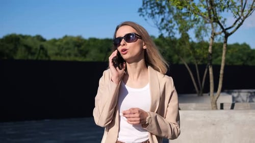 Young Woman Talking on Cell Phone Outside