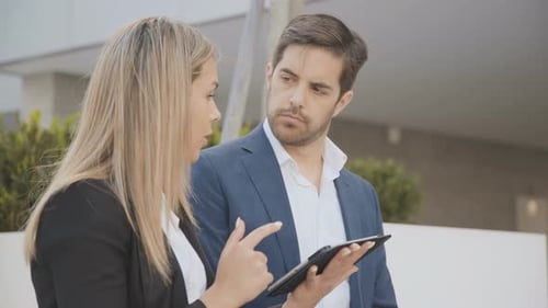 Business Colleagues Discussing Data on Tablet